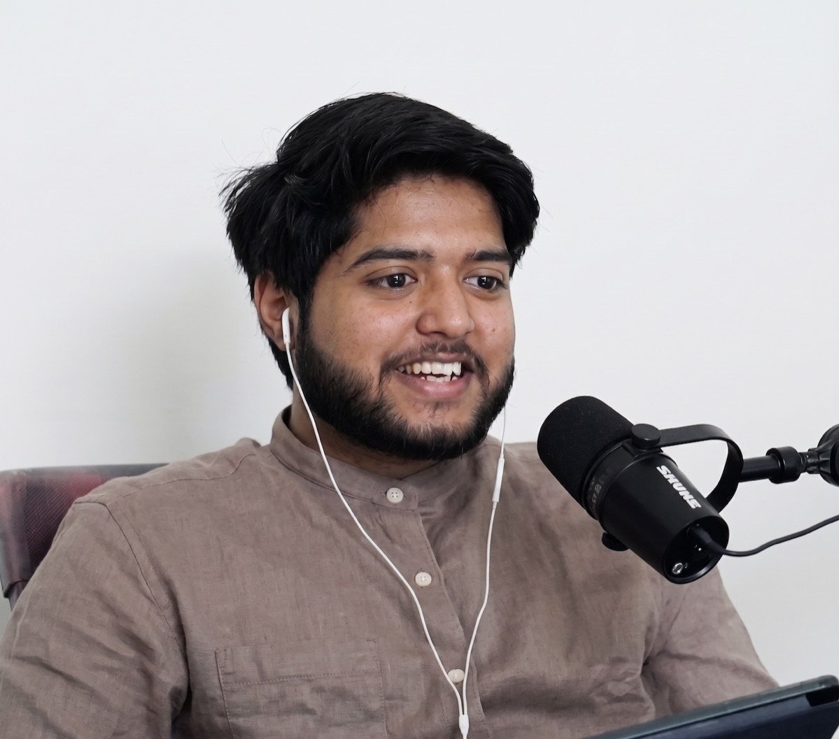 Ashish Arya speaking into a microphone
